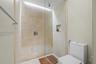 Shower with tiled walls, recessed niche, and clear glass enclosure