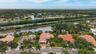 Residential community featuring multiple water features, mature trees, and varying architectural styles