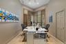 Vaulted ceiling with recessed lighting, wood-finish plantation shutters, paneled door, and tile flooring