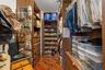 Custom closet system featuring wood-finish cabinetry, integrated shelving, and hanging rods