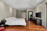 Wood-finish flooring, recessed lighting, and a tray ceiling