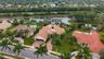 Tile roof residence with a paver driveway, an integrated garage, and a swimming pool