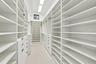Custom closet system featuring extensive shelving, built-in drawers with modern pulls, and integrated lighting