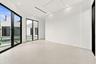 Expansive room with large format tile flooring, recessed lighting, and a tray ceiling
