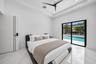 White walls with a tray ceiling, recessed lighting, and a modern ceiling fan