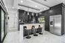 Contemporary kitchen featuring dark wood cabinetry, a waterfall island, and stainless steel appliances