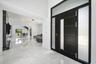 Modern entry door with frosted glass panels, white marble-look flooring, built-in media console, and a contemporary ceiling light fixture