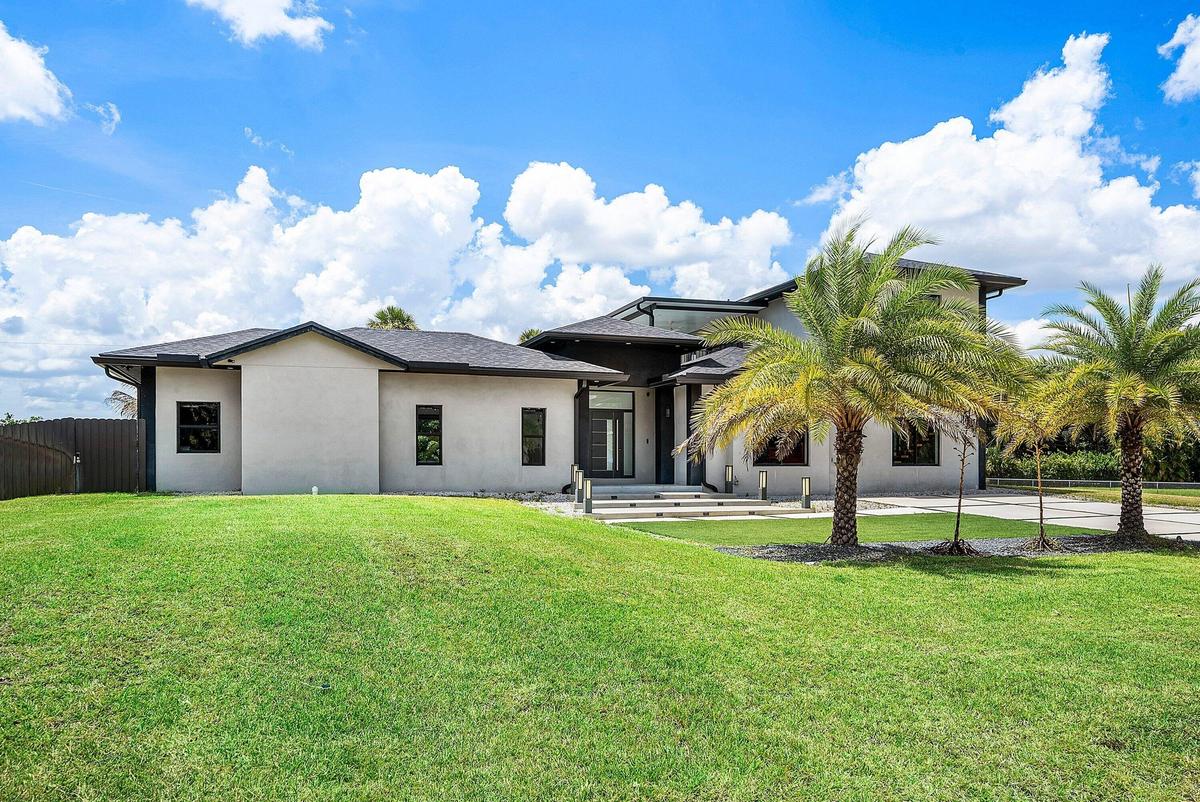 Modern stucco exterior with a dark trim roofline
