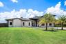 Modern stucco exterior with a dark trim roofline