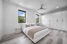 Recessed lighting, wood-finish flooring, white built-in cabinetry with drawers, and a ceiling fan with integrated lighting