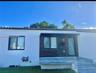 White stucco exterior with a terra cotta tile roof