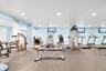 Fitness room featuring recessed lighting, light blue walls, and rubberized flooring