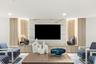 Built-in media console with wood-finish cabinetry, integrated shelving, and a stone-look accent wall