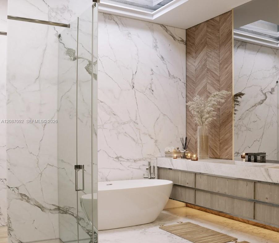 Freestanding soaking tub, glass-enclosed shower, wall-mounted vanity with integrated lighting, wood-finish chevron accent wall, and skylight