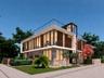 Modern architectural design featuring expansive glass walls, stone facade, multiple balconies with metal railings, and a flat roofline