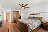 Primary bedroom w/walk-in closet w/built-in shelving.