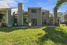 Expansive lawn area with a gravel patio and sliding glass doors