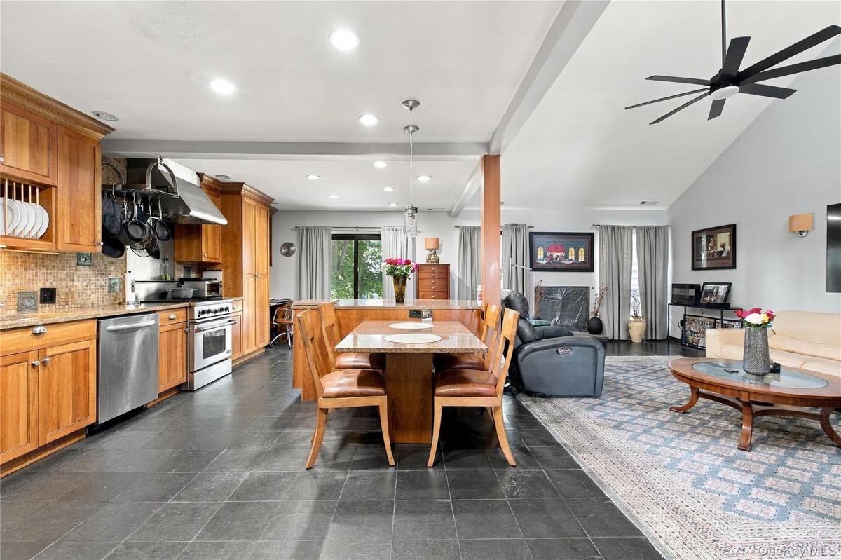Gourmet kitchen with stainless steel appliances, granite counter and island