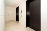 Light-toned tile flooring, white walls, and two dark-paneled elevators