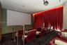 Dedicated theater room featuring a large projection screen and ceiling-mounted projector