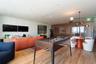 Recessed ceiling lighting, wood-finish flooring, and a decorative slatted wood partition