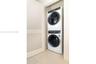 Stacked front-load washer and dryer set, integrated into a recessed alcove
