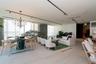 Open-concept living space with expansive windows, a modern chandelier, track lighting, and light-toned tile flooring