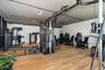 Dedicated fitness area featuring multiple exercise machines, wood-finish flooring, recessed lighting, and track lighting