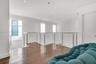 Hardwood flooring, contemporary cable railing, recessed lighting, white walls, and multiple windows