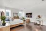 Recessed lighting, wood-finish flooring, two windows, and white walls