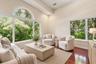 Vaulted ceiling with recessed lighting, expansive windows, large arched transom window, wood-finish flooring, and a neutral color palette