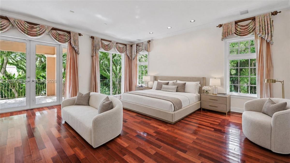 Hardwood flooring, recessed lighting, French doors, large windows, and an outdoor balcony with railings