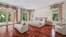 Hardwood flooring, recessed lighting, French doors, large windows, and an outdoor balcony with railings