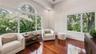 Hardwood flooring, vaulted ceiling, recessed lighting, expansive windows, arched transom window