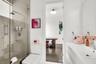Glass-enclosed shower with tile surround and rain showerhead