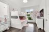 Rich wood-finish flooring, bright white walls, and recessed lighting