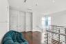 Hardwood flooring, recessed lighting, white walls, louvered door, and stainless steel railing