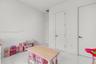 White walls with multiple doors, white tile flooring, and flush-mounted ceiling lighting