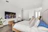 Recessed lighting, wood-finish flooring, white walls, and French doors with privacy curtains