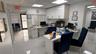 Recessed lighting, built-in white cabinetry, white walls, and white tile flooring