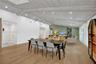 Vaulted wood-finish ceilings with recessed lighting, light wood-finish flooring, white walls, and a green accent wall