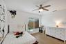 Recessed window with blinds, wood-finish flooring, and a ceiling fan with integrated lighting