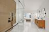 Dual vanity with rectangular sinks, wood-finish cabinetry, and matte black fixtures