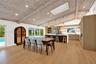 Vaulted wood-finish ceiling with exposed beams and recessed lighting