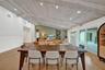 Vaulted ceiling with exposed beams and recessed lighting