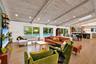 Vaulted wood-finish ceiling with exposed beams, wood-finish flooring, sliding glass doors, recessed lighting, and a skylight