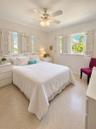Smooth flooring, white interior walls, white window shutters, and a ceiling fan with integrated lighting