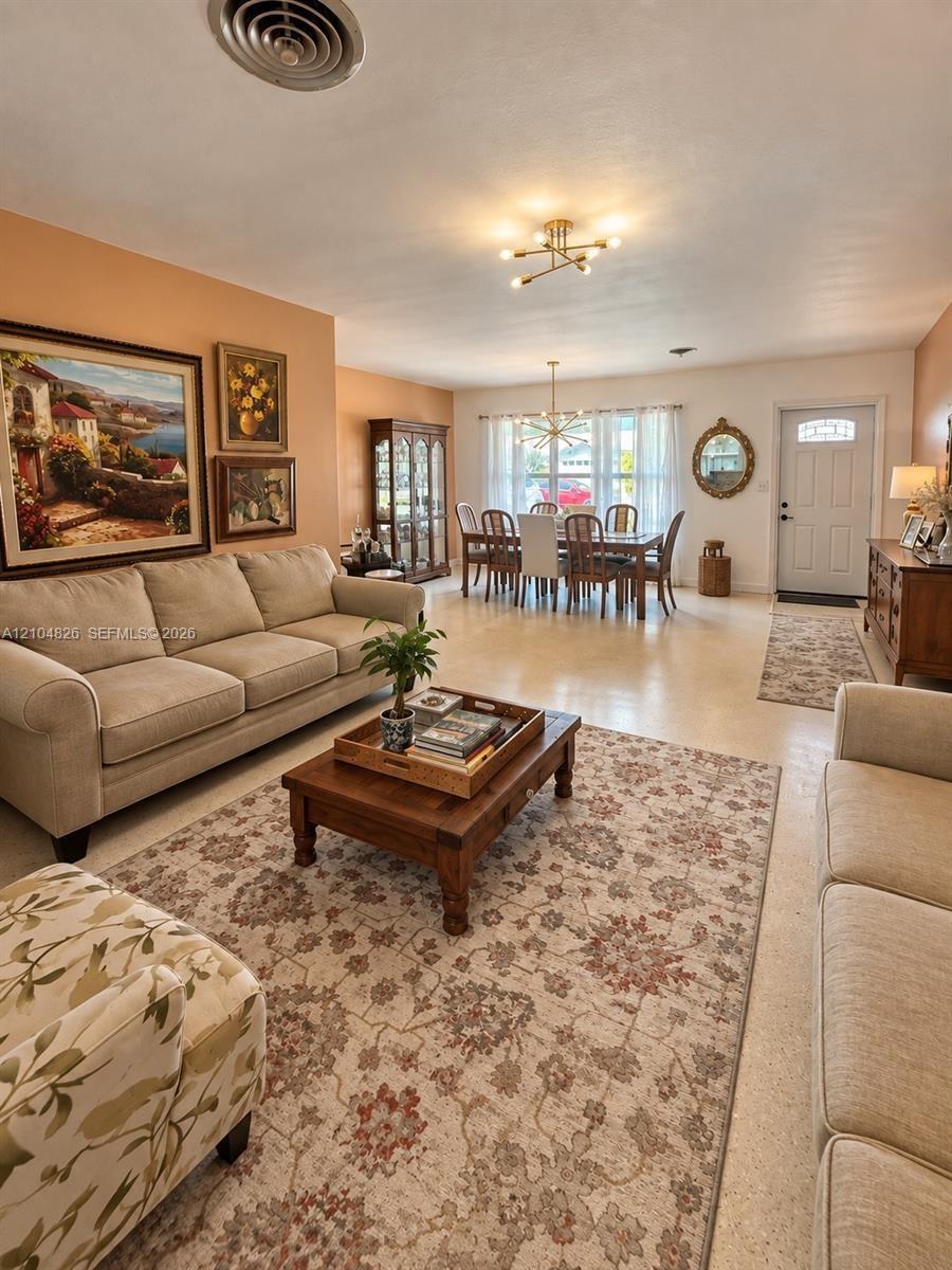 Open-concept living area with smooth ceilings and neutral wall tones