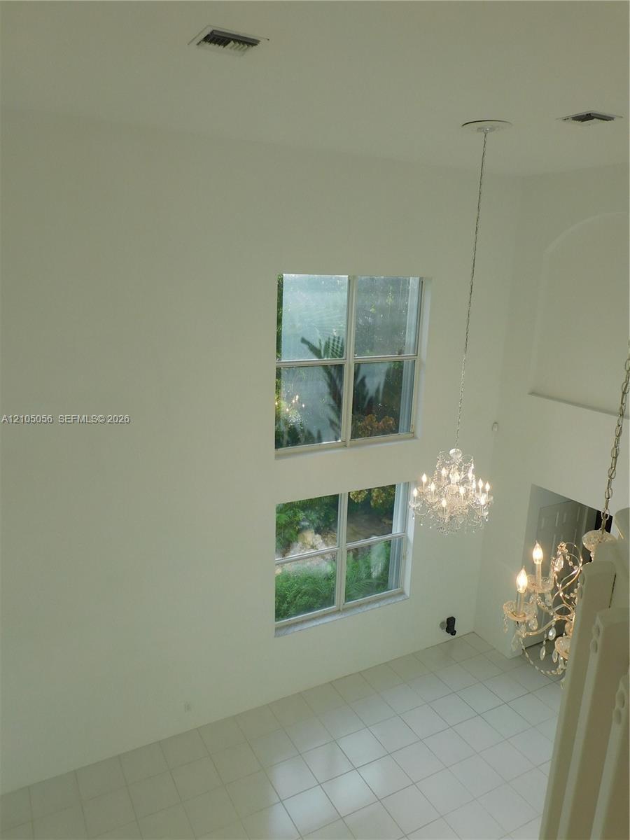 Living and Dining Room with lots of natural light - high ceiling elevate the sense of spaciousness.