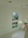 Living and Dining Room with lots of natural light - high ceiling elevate the sense of spaciousness.